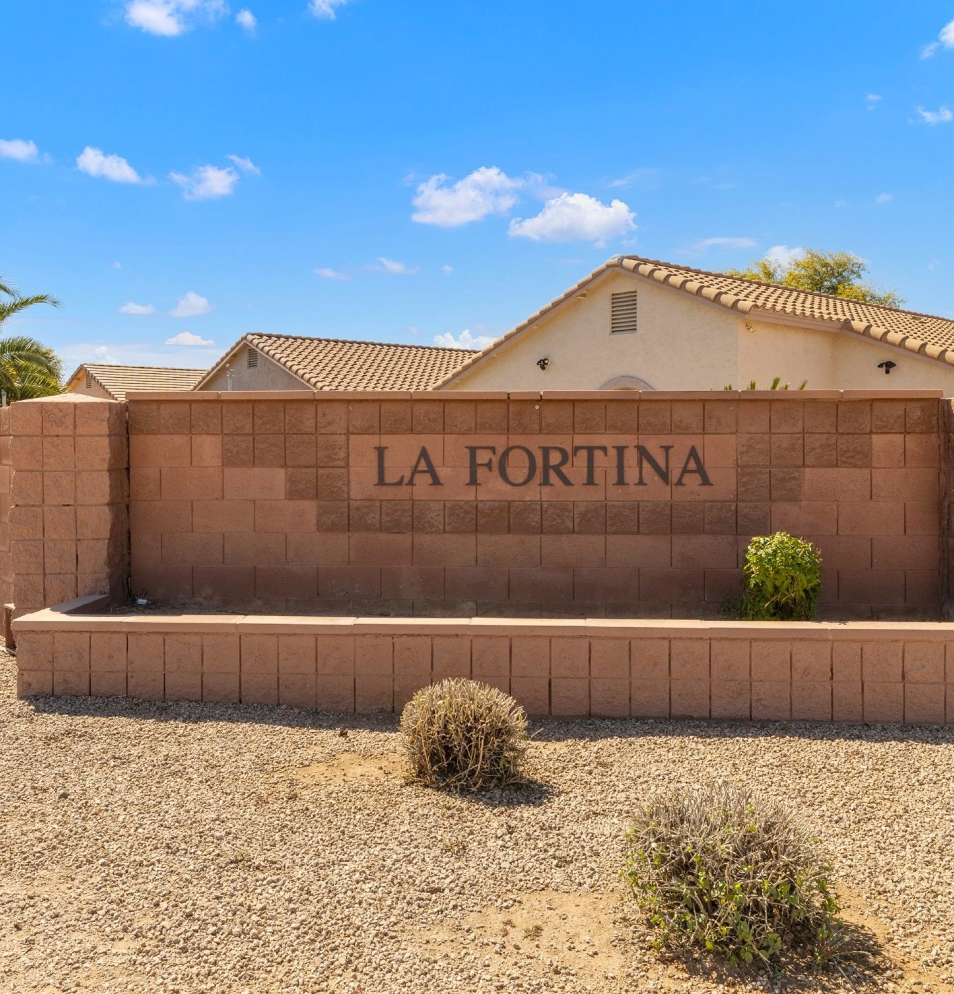 Close-up of the La Fortina neighborhood entrance sign featuring stacked stone masonry and modern metal lettering in Mesa, AZ.